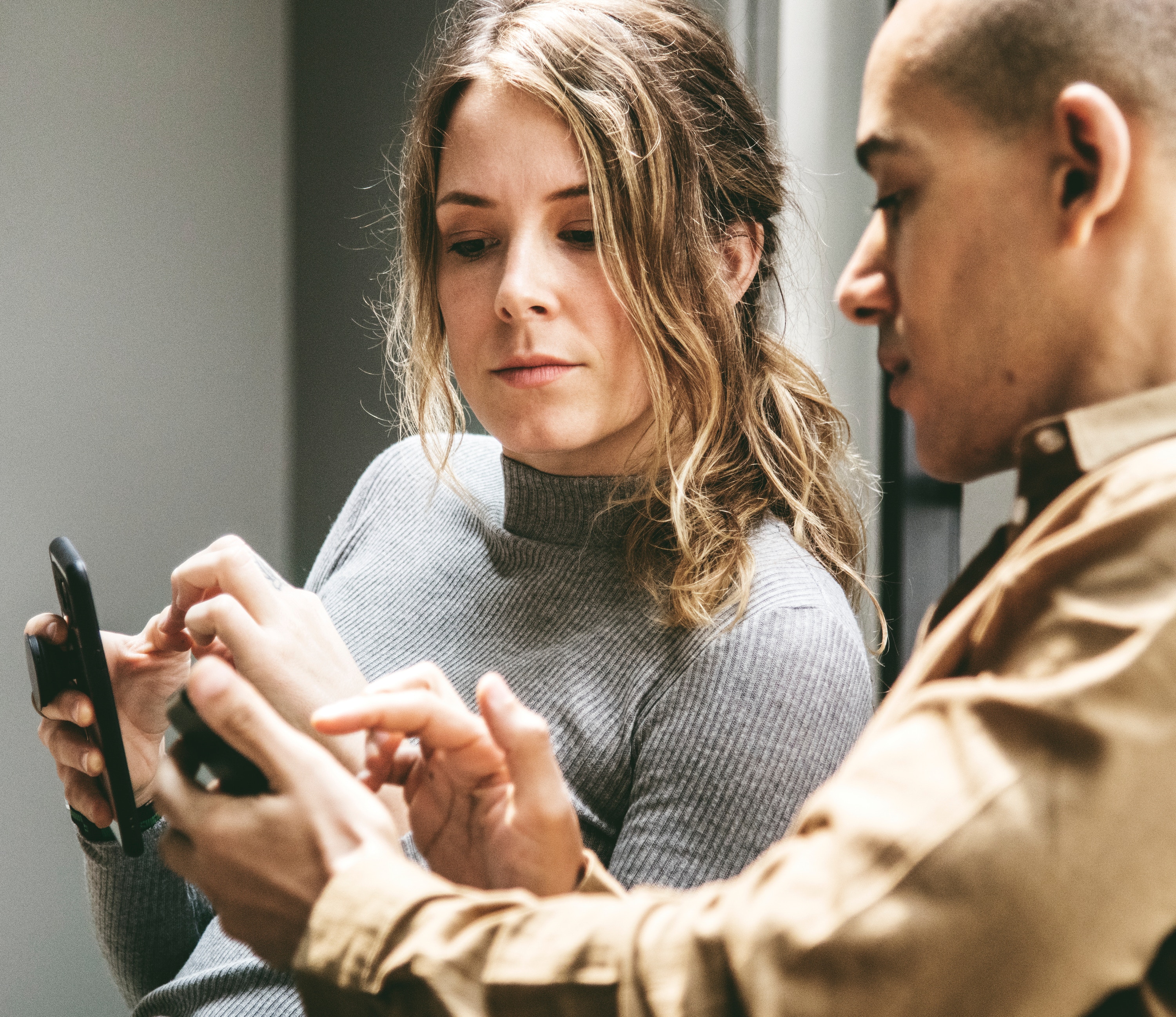 woman-and-man-doing-marketing-research-on-smartphones